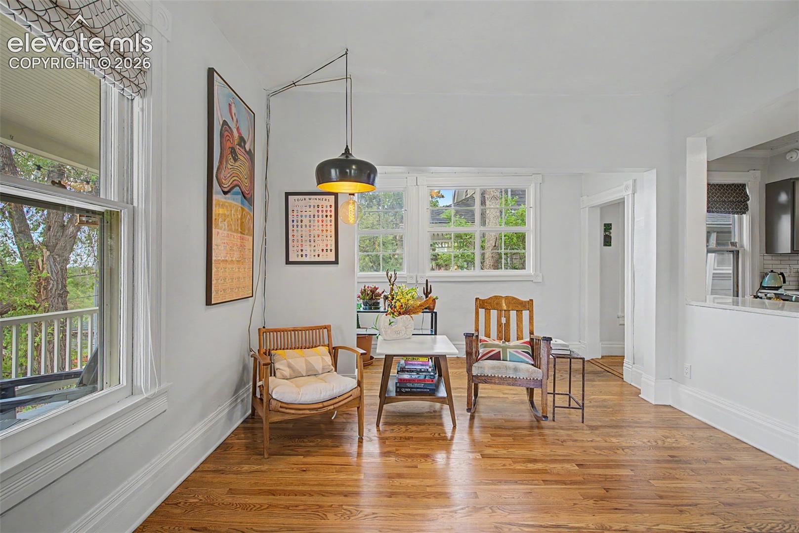 Living room featuring hardwood flooring and bright natural light
