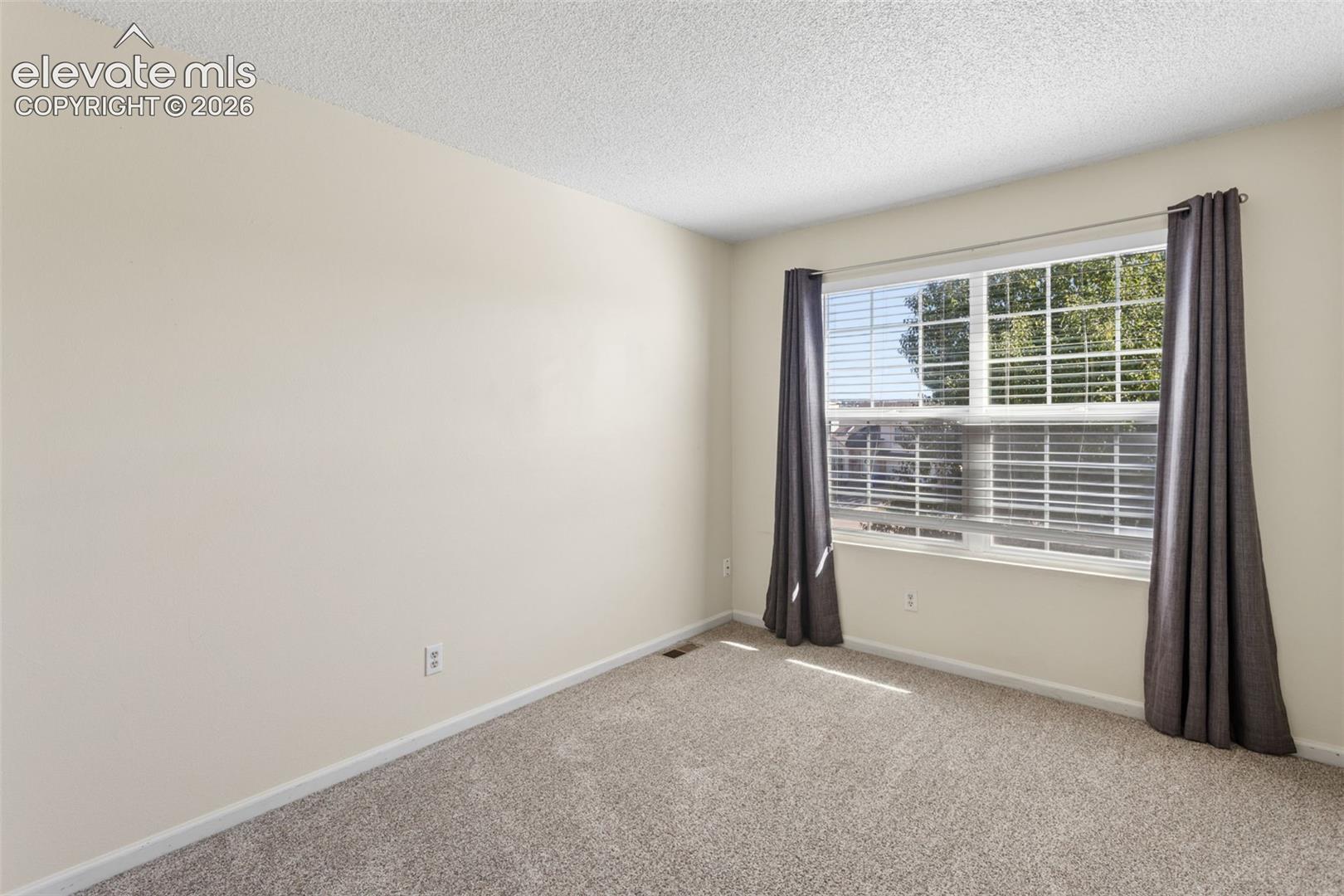 Bedroom three with carpet