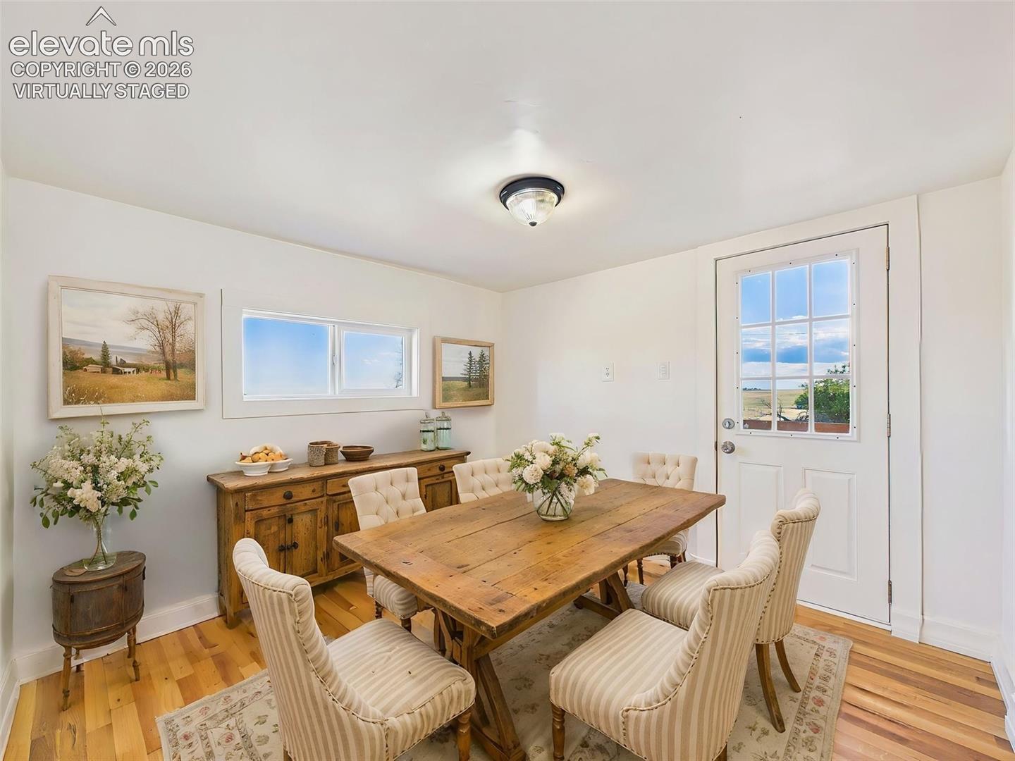 (Virtually Staged) Dining Room – Charming dining space offers room for a full-size table and overlooks the surrounding landscape through large windows.
