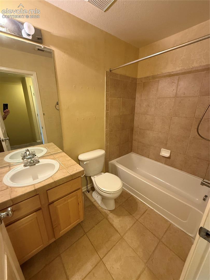 2nd full Bath featuring ceramic tile wall