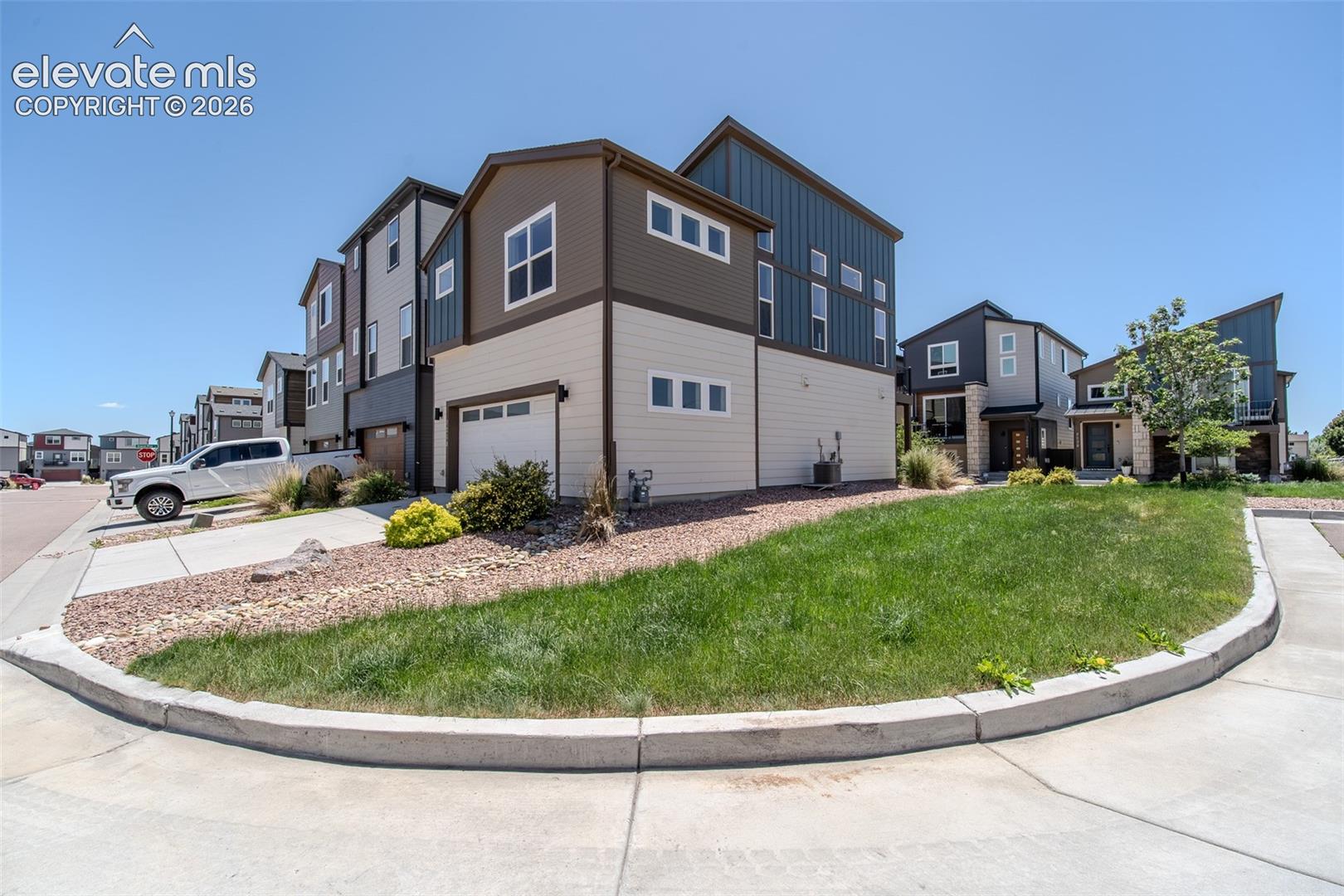 Side and rear view of home with 2-car attached garage.