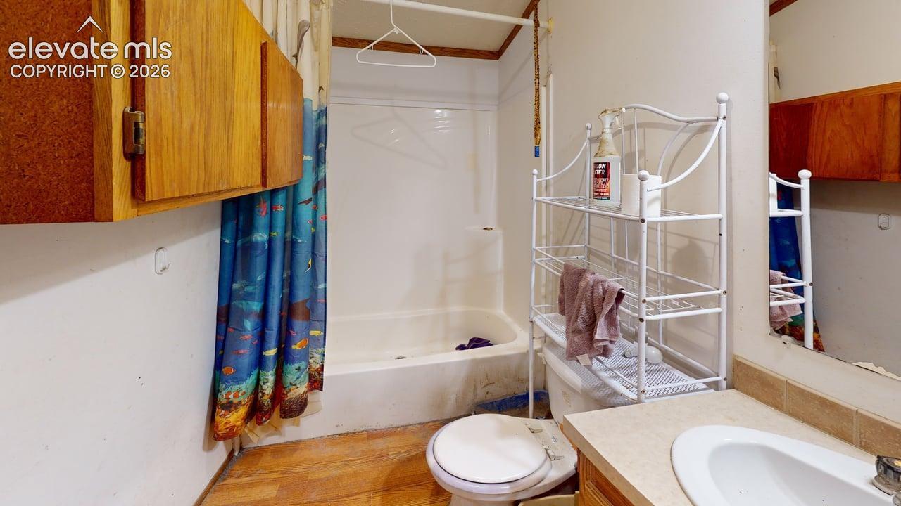Bathroom with shower / tub combo with curtain and vanity