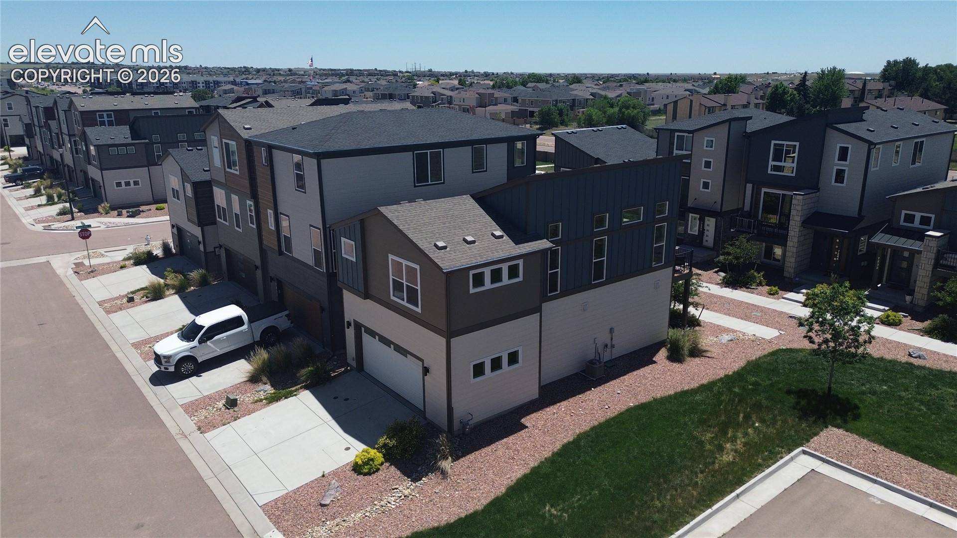 Aerial rear and side view of home and xeriscaped lot.