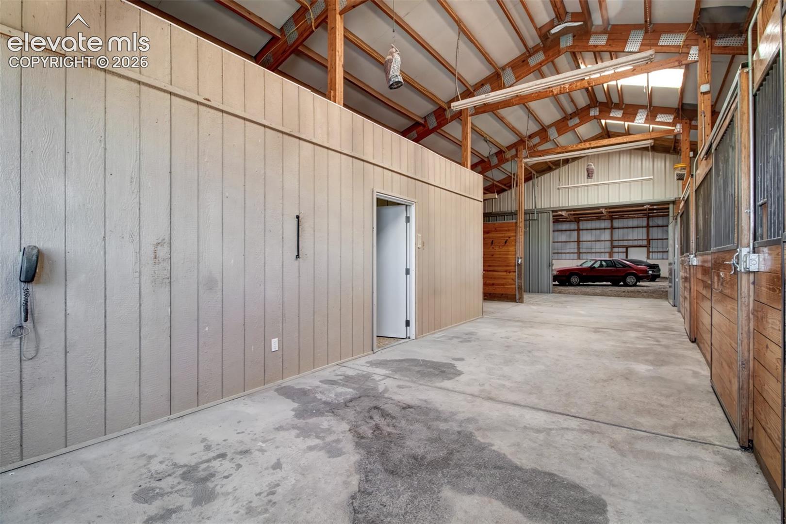 Looking Into The Arena With 3-Stalls And Hay Stall On The Right, Caretakers Quarters, And Wash Bay On The Left