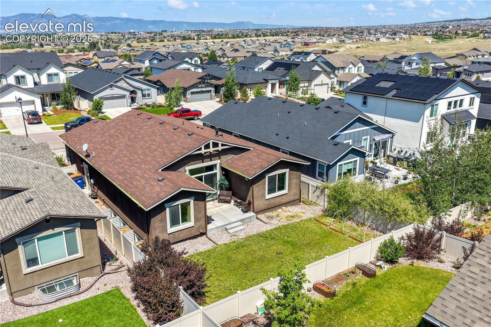 Back aerial view showing landscaping and mountain views