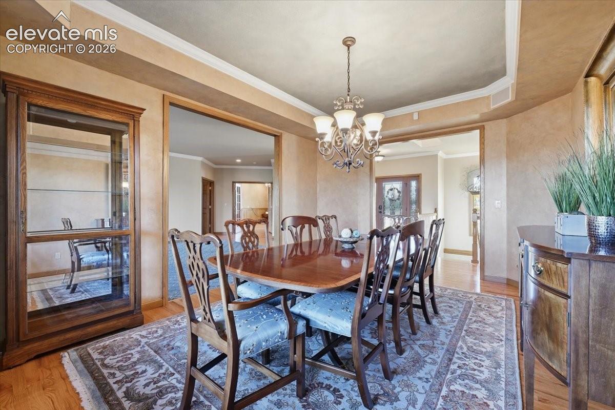 A stunning tray ceiling and crated faux finished provide incredible depth within the formal dining room. 