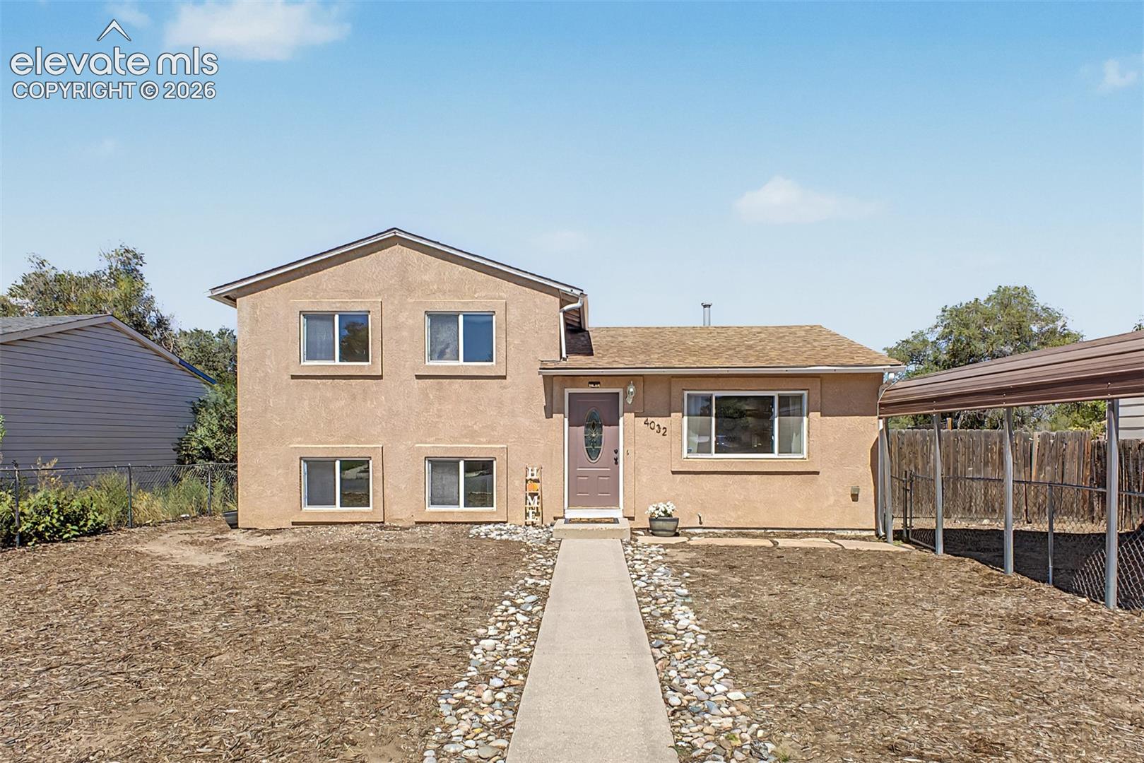 Stucco exterior fenced yard and low maintenance landscaping. 