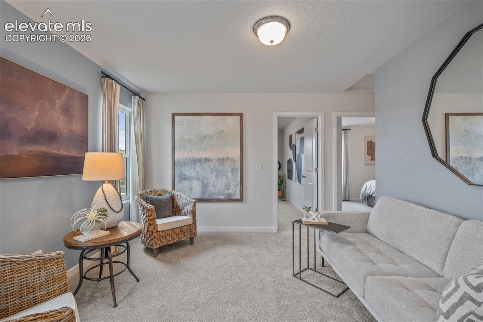 Recessed lighting, light-toned carpeting, ample natural light, and neutral wall tones