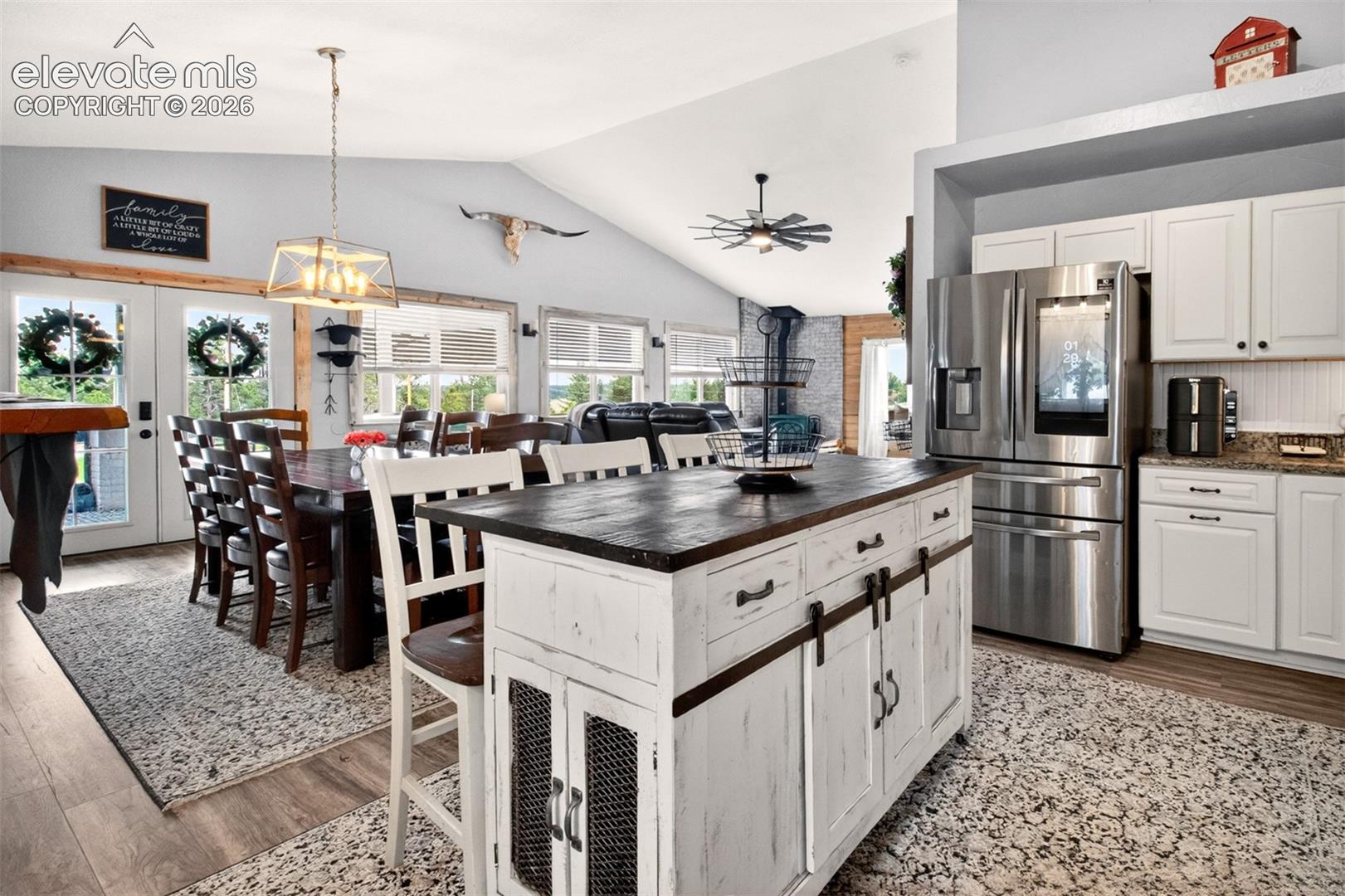 Nice open-concept layout with newer LVP flooring, granite counters, and high-end stainless steel appliances!