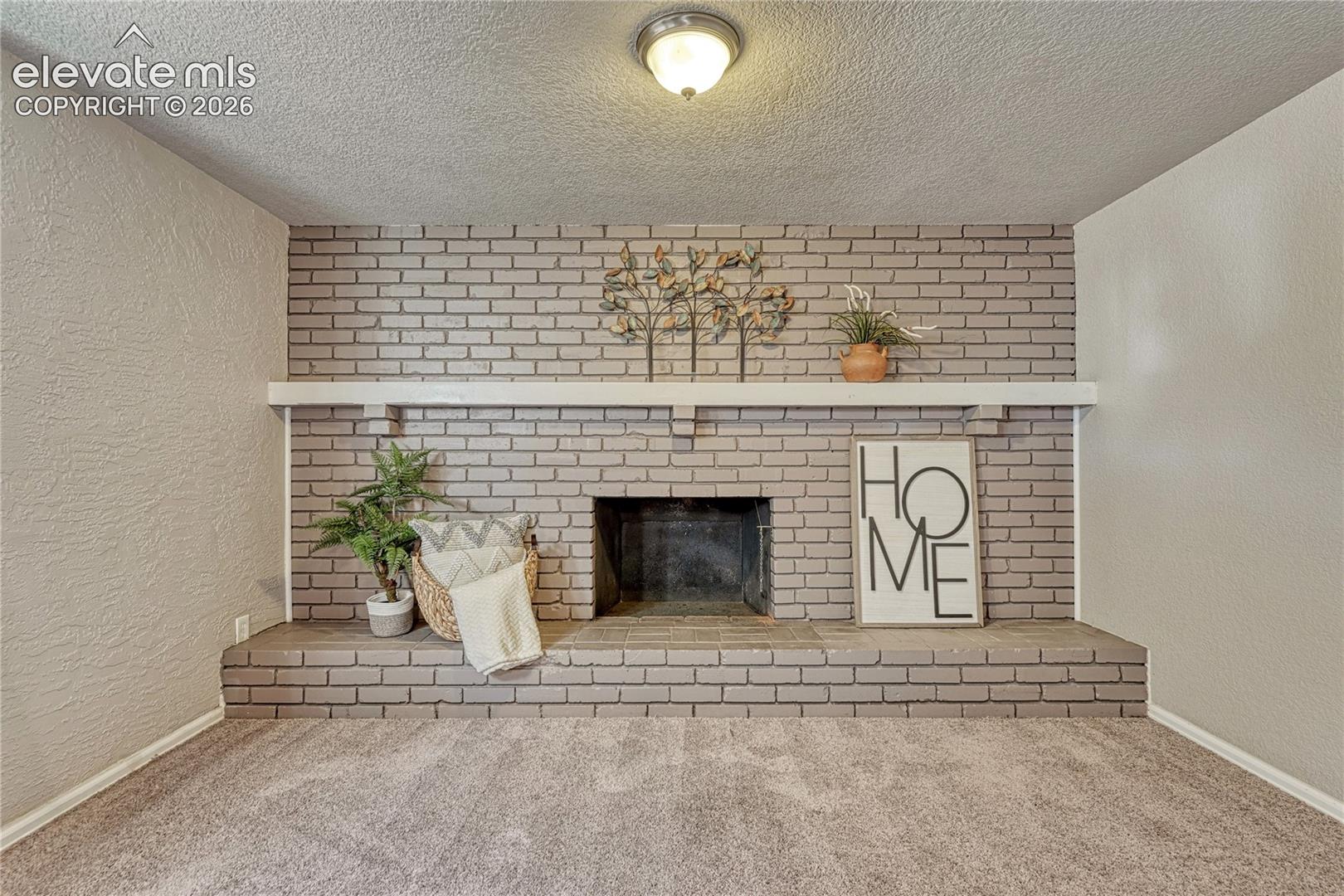 Huge basement family room with beautiful brick fireplace!