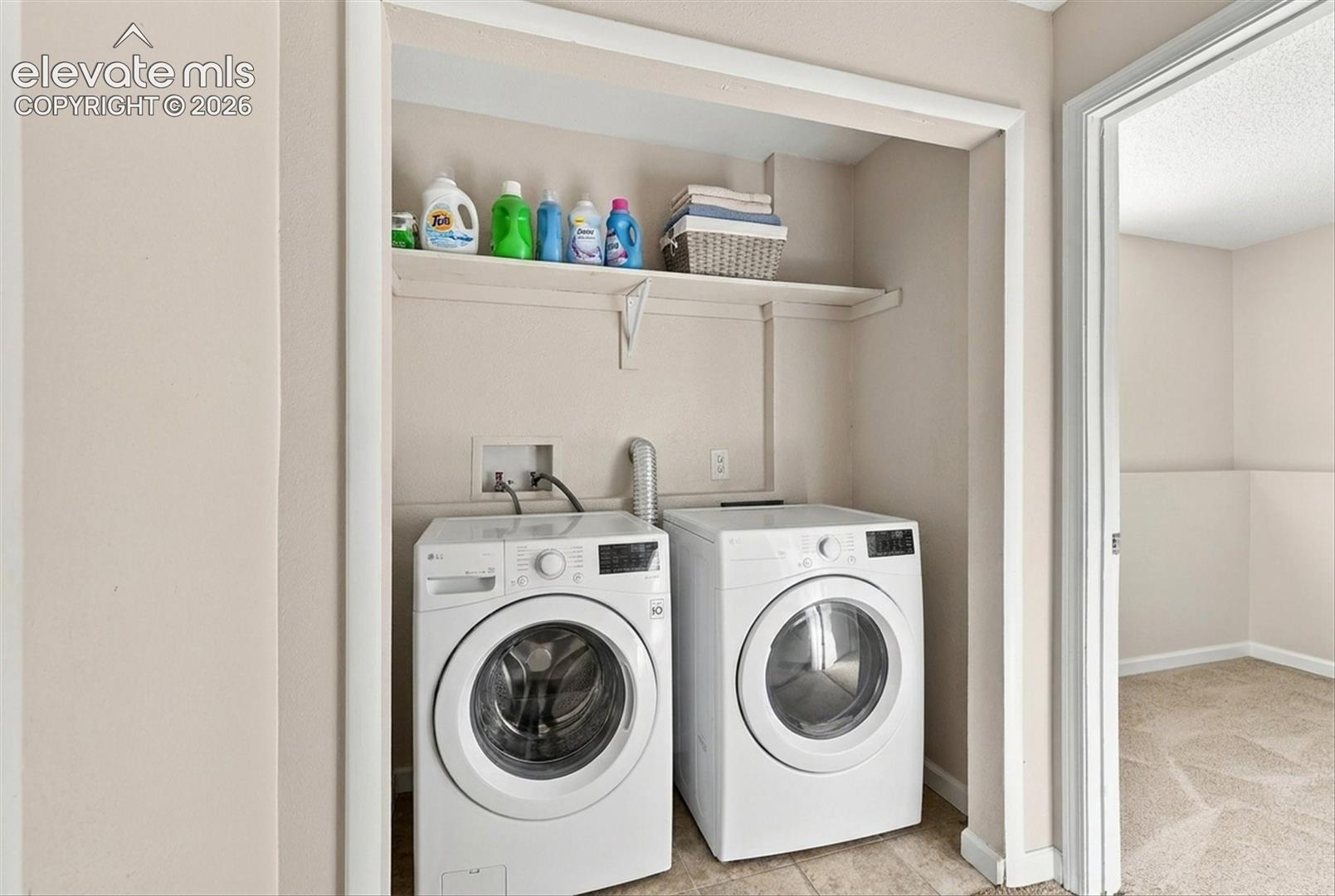 Laundry closet featuring a built-in overhead storage shelf