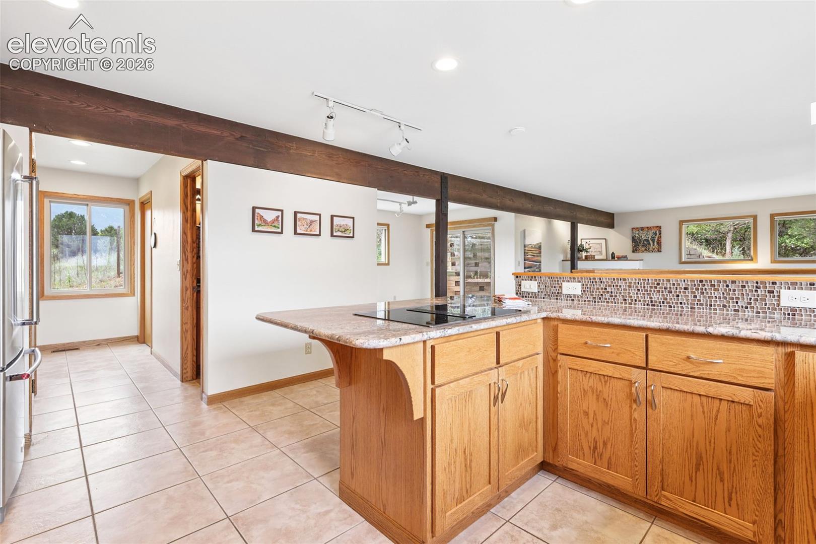 Down the hallway is a pantry, desk area, laundry, and 1/2 bath.
