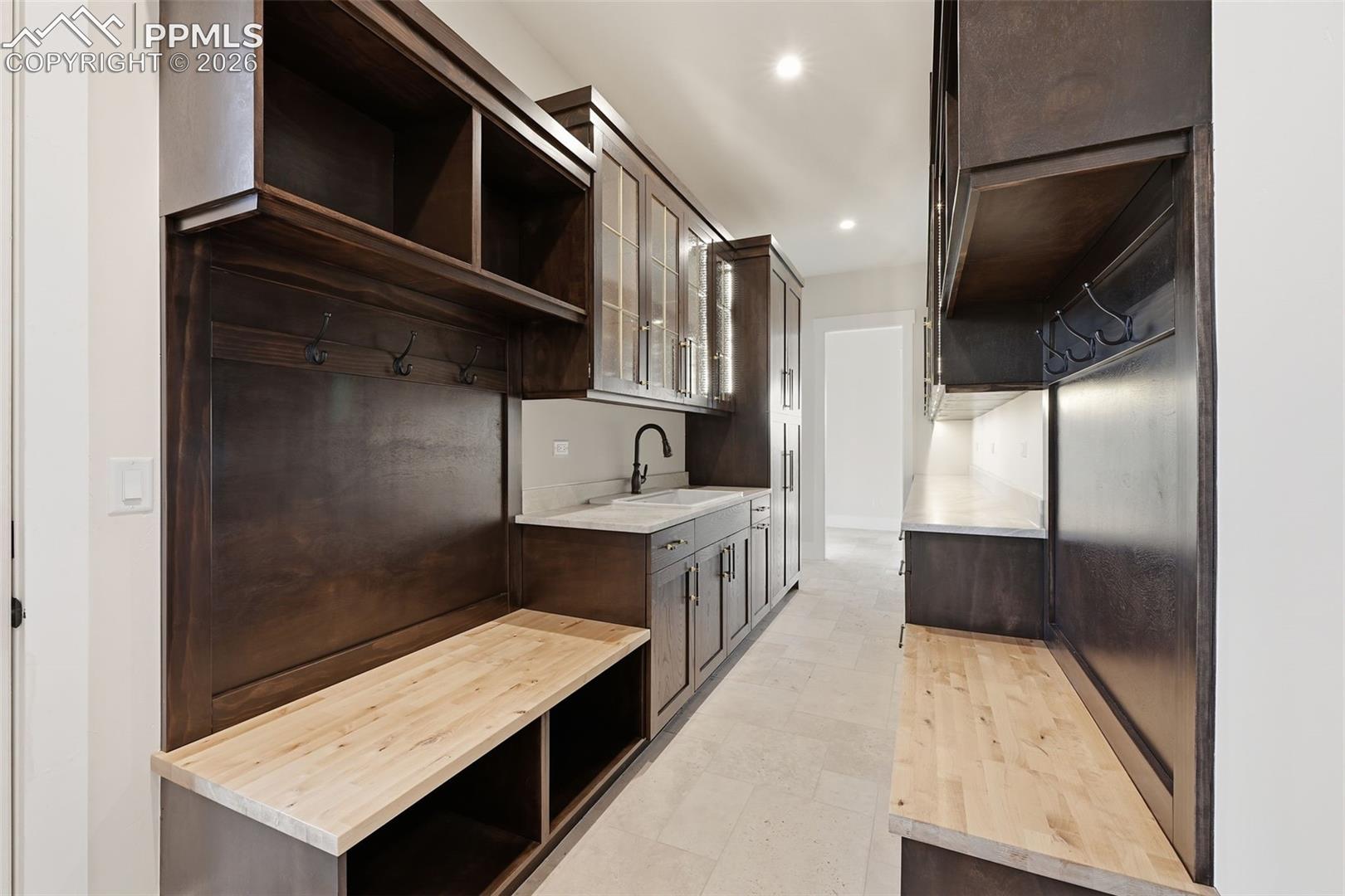 Kitchen Galley with prep sink, benches with storage.