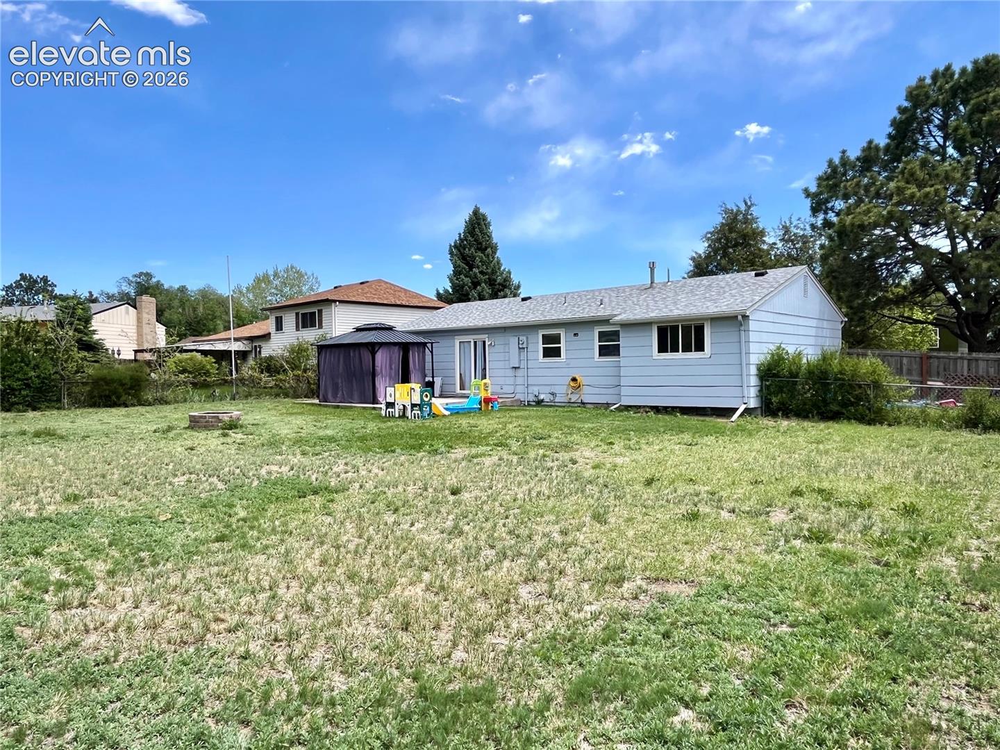 Large fenced backyard with storage shed included