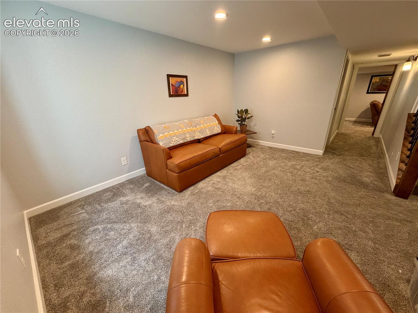 Carpeted basement room featuring recessed lighting and white baseboards