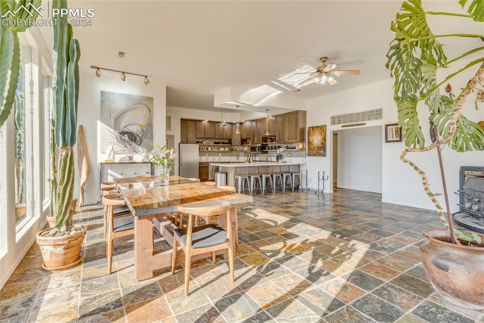 Dining room with dark tile flooring and ceiling fan
