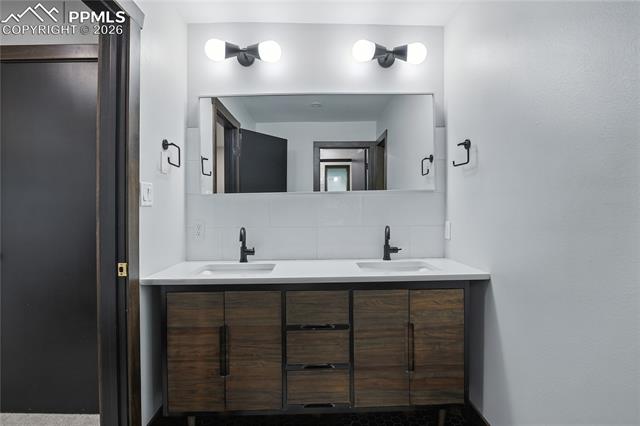 Bathroom with decorative backsplash and double vanity