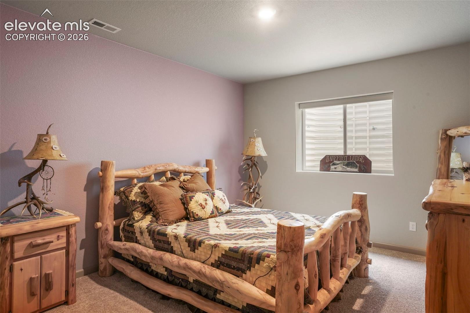 Bedroom featuring soft purple and gray wall tones