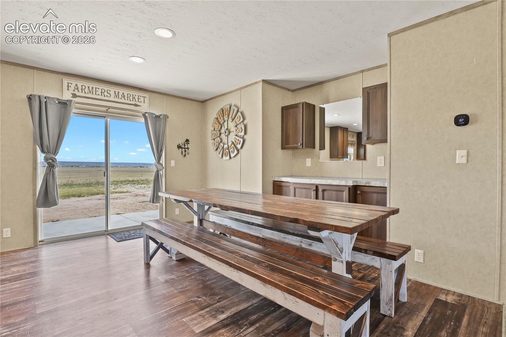 Sliding glass door, wood-finish flooring, recessed lighting, built-in cabinetry, and countertop surface