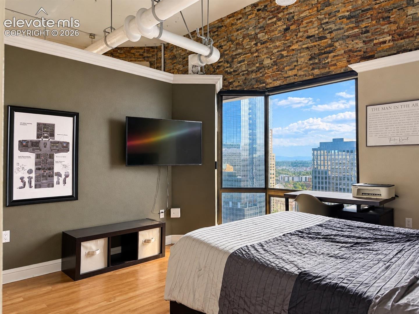 Expansive corner window with city and distant mountain scenery