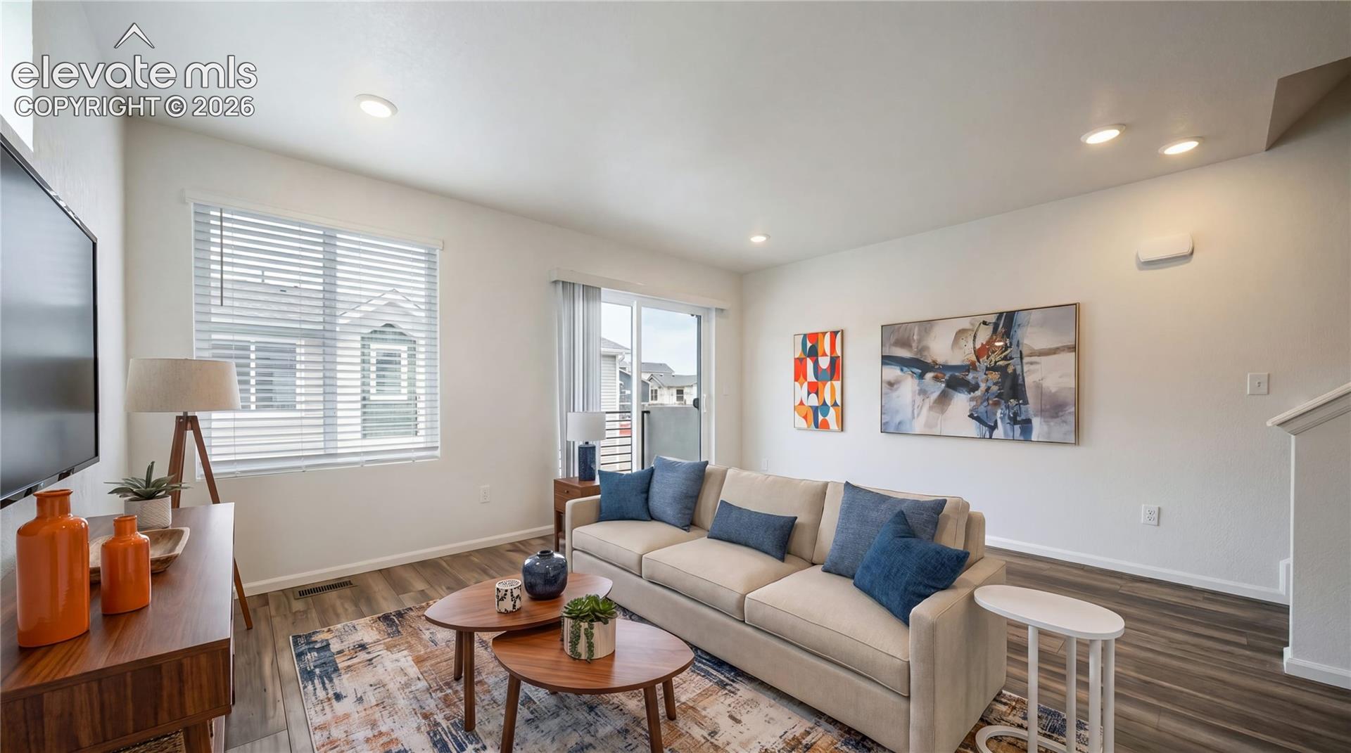 Recessed lighting, wood-finish flooring, white walls, and a sliding glass door
*photos of a model home*