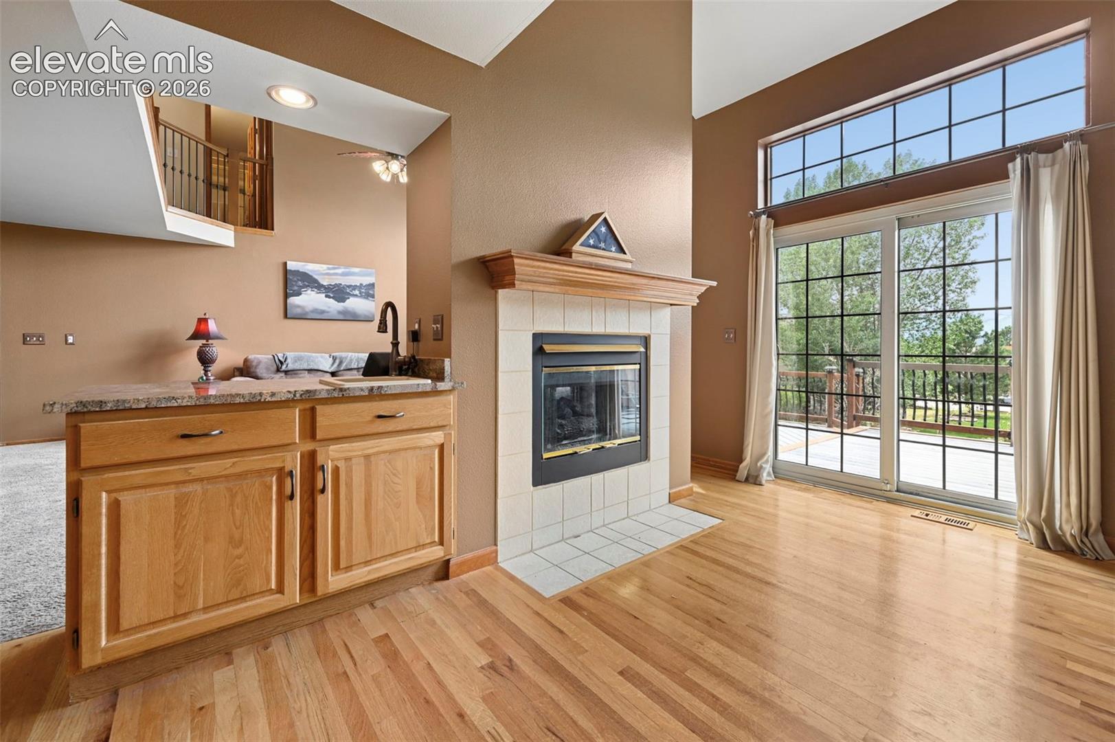 Transition between kitchen and family room with a sink and fireplace.