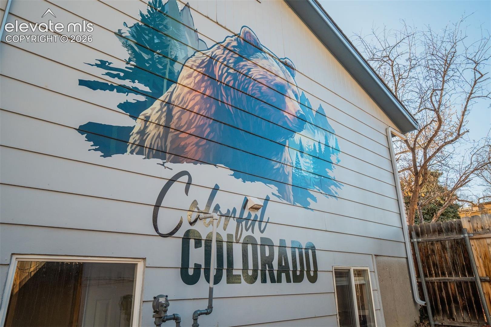Siding exterior featuring a large, colorful mural