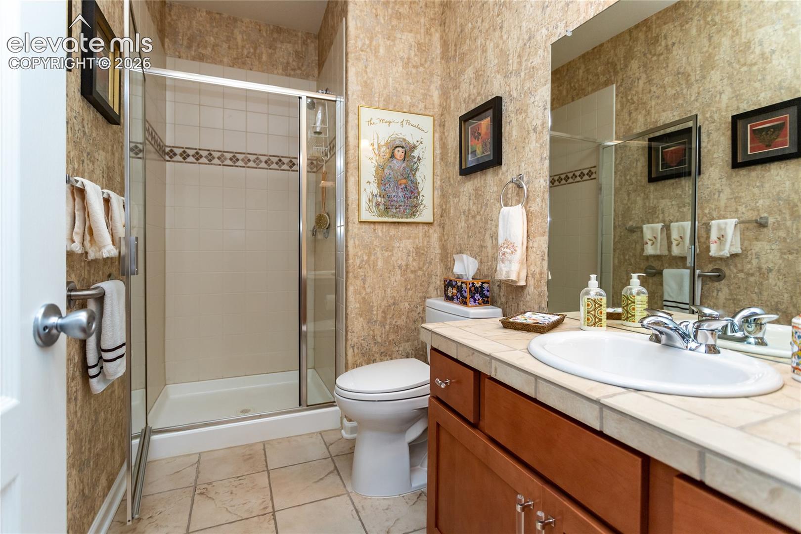 Secondary bathroom is spacious with plenty of storage.