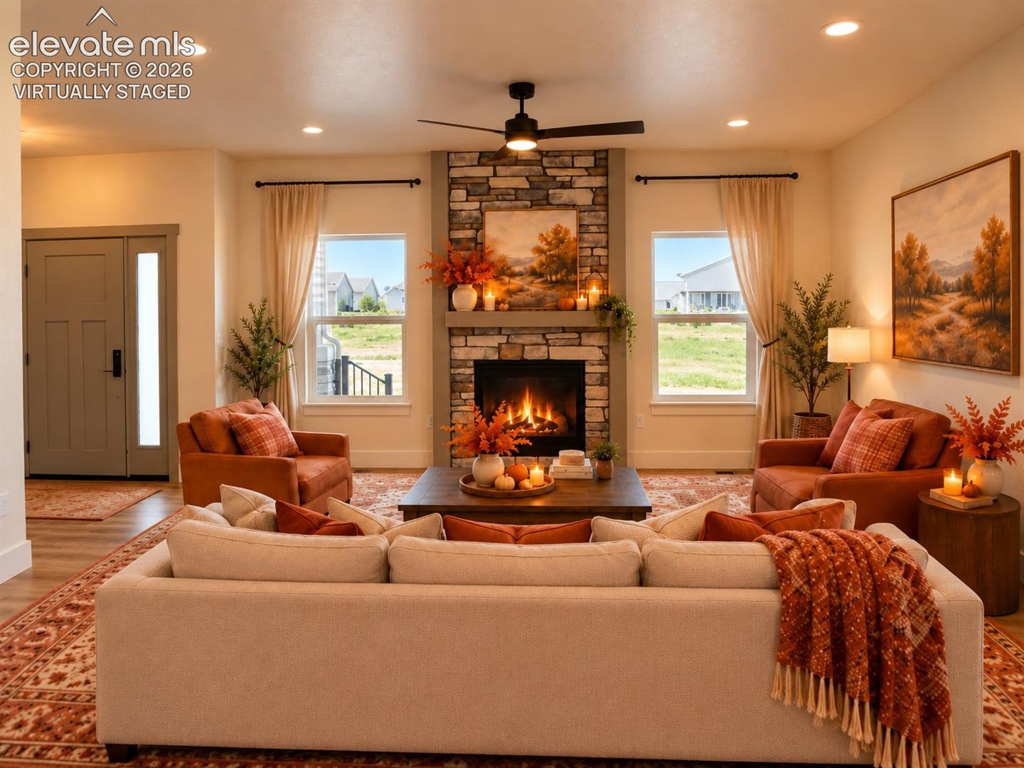 Virtually staged Living area featuring a stone-clad fireplace, built-in recessed lighting, a ceiling fan, and a wood-finish entry door with a frosted glass sidelight