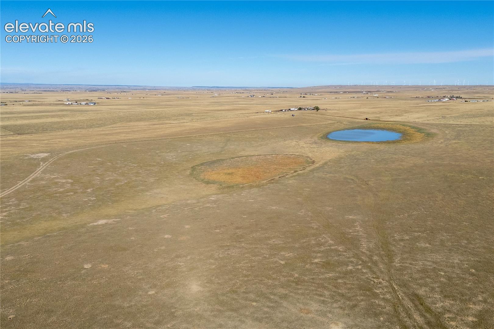 Expansive acreage featuring natural terrain and a pond