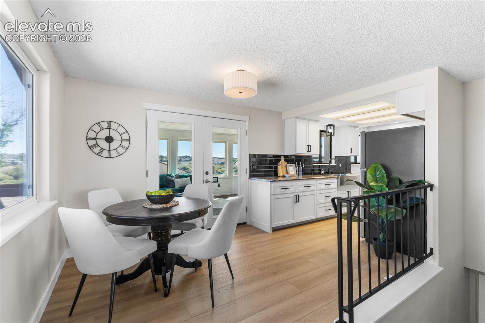 This open floor plan and lots of windows allows this 1200 sq ft rancher feel even larger. Plus, through the double doors is additional sq foot in the finished sun room.
