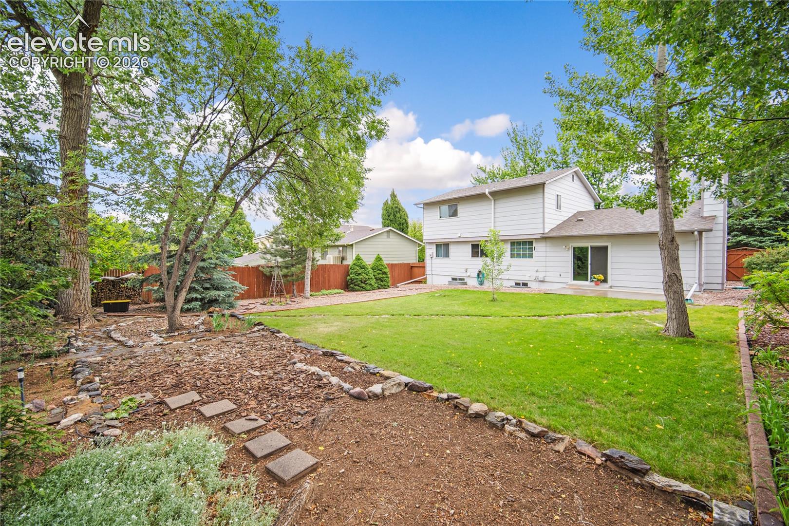 Fully landscaped backyard with mature trees.