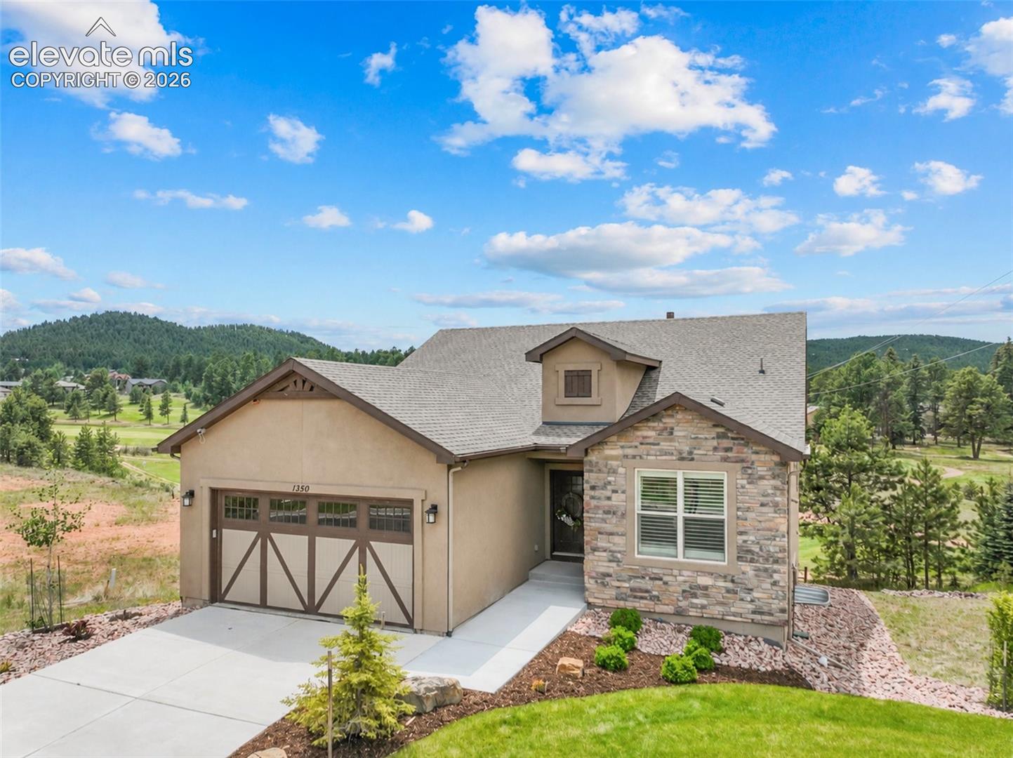 Experience luxury, style, and effortless living in this stunning Golf Course Villas residence that shows like a model home. Perfectly positioned along the golf course with breathtaking Pikes Peak views, this upscale main level living home offers exceptional craftsmanship, modern finishes, and true main-level living.The light-filled great room features soaring vaulted ceilings, a cozy fireplace, luxury vinyl plank flooring, Restoration Hardware light fixtures and seamless access to a covered composite deck complete with a gas hookup for grilling—ideal for entertaining while enjoying the mountain views. The gourmet kitchen is beautifully appointed with quartz countertops, double ovens, a gas cooktop, refrigerator, dishwasher, and abundant workspace for the home chef.A private office with French doors provides the perfect work-from-home retreat. The deluxe primary suite offers a spacious walk-in closet and an elegant spa-inspired bath designed for comfort and relaxation.The walkout lower level features a large family room with wet bar and quartz countertops, opening to a patio just steps from the golf course. Two generous guest bedrooms and an adjoining bath provide plenty of room for family and visitors.Additional highlights include plantation shutters throughout, a whole-house ventilation system, electric vehicle charger in garage and quality finishes at every turn.