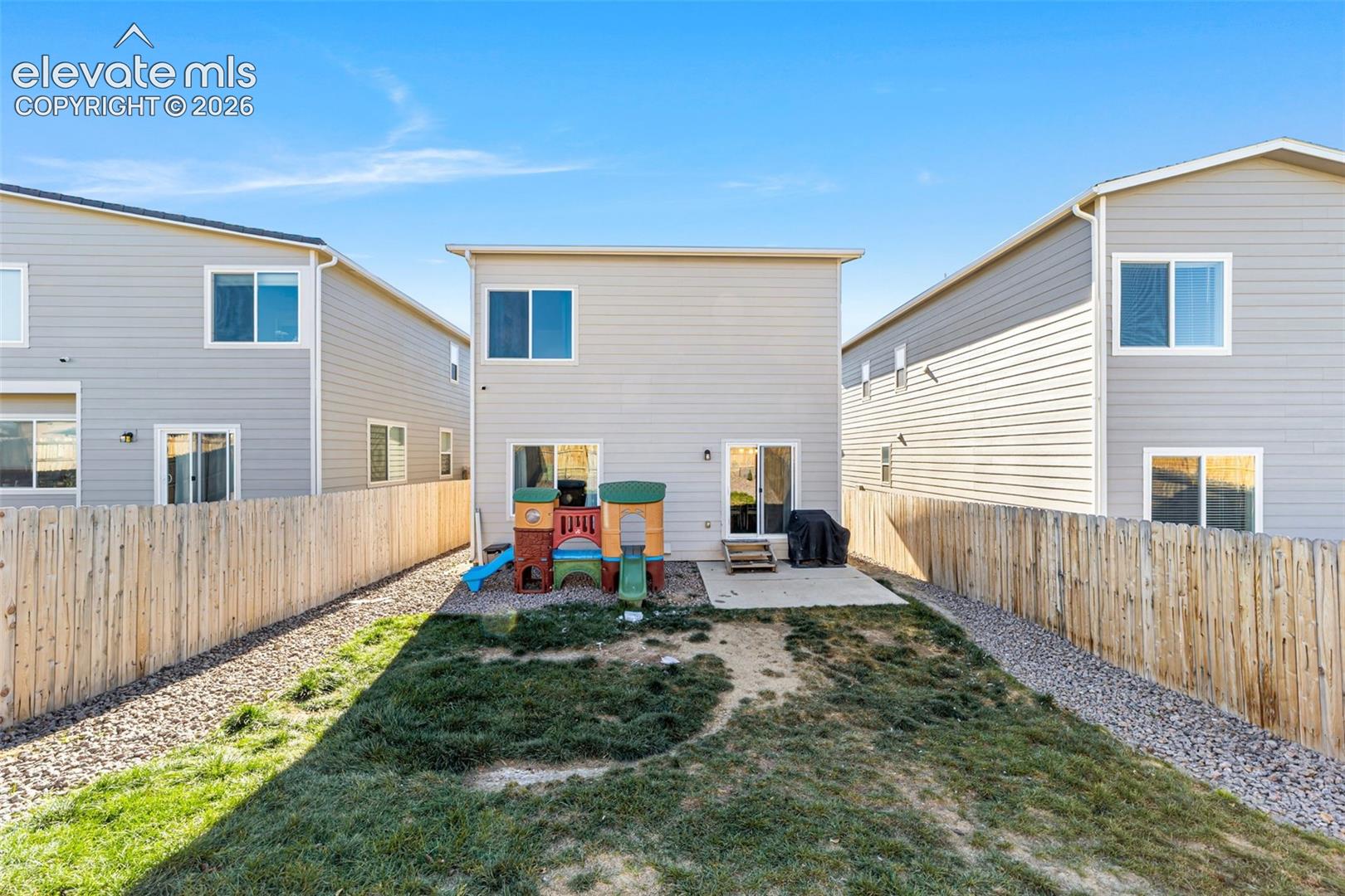 Fully fenced backyard with patio space.