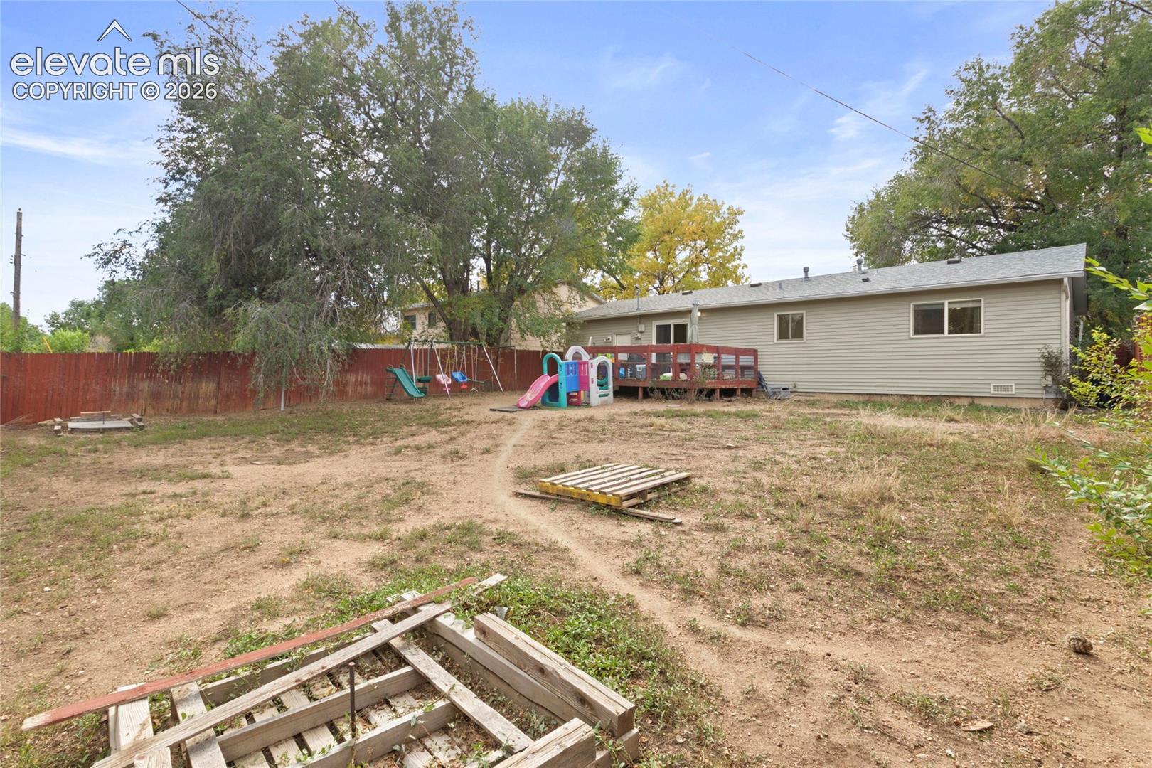 Fully fenced in back yard with gate access to fenced front yard and the back garage entrance