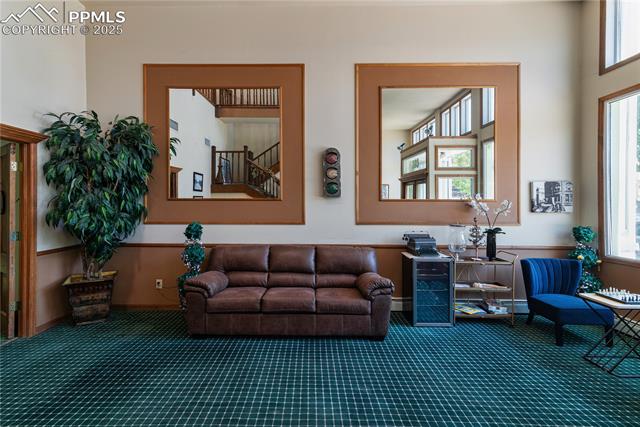 Living area with plenty of natural light and carpet floors