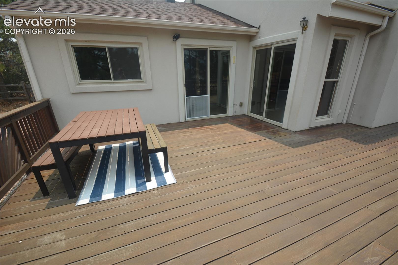Looking from deck toward living room and primary bedroom walk-outs. 16x17 portion of the deck