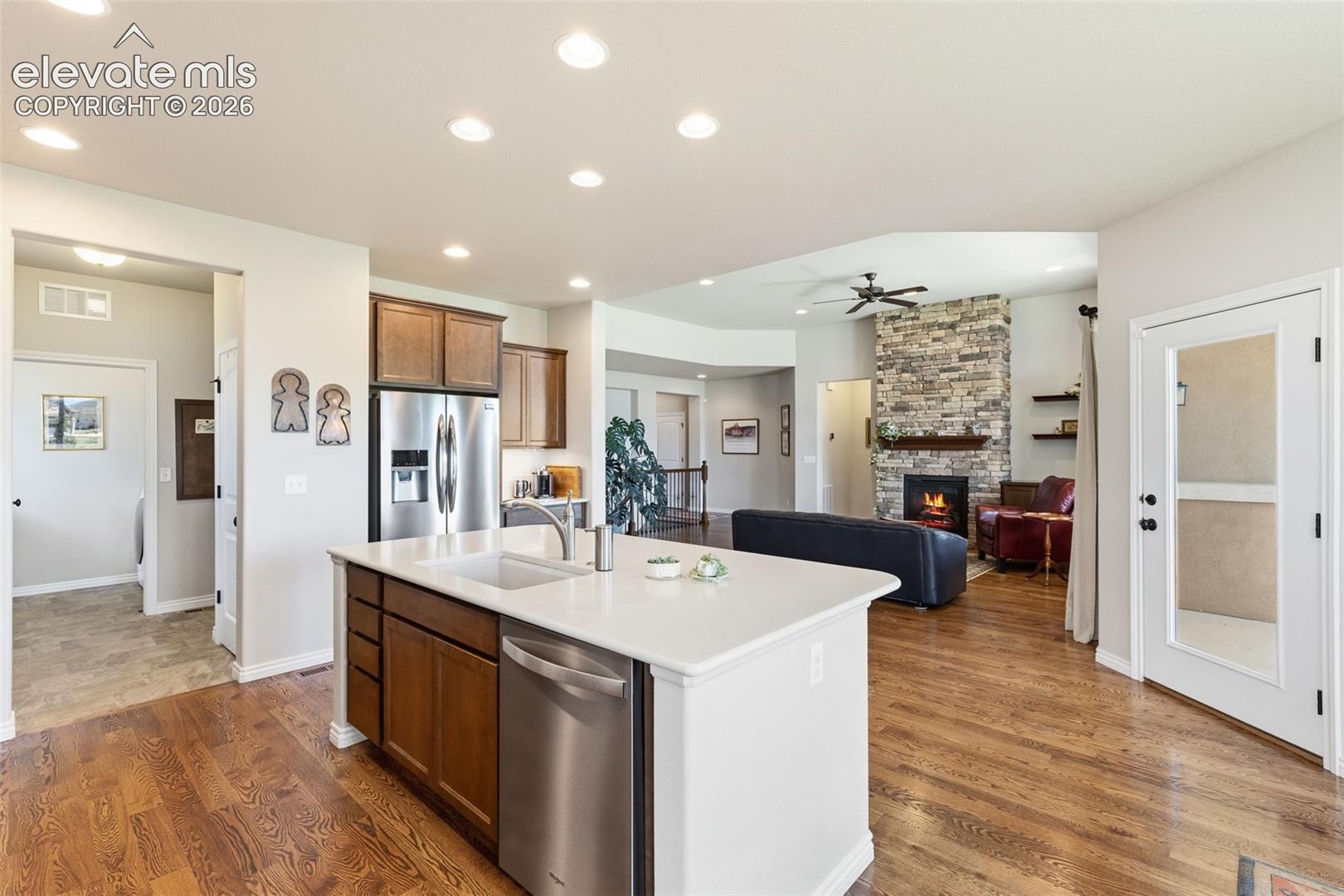 View of open floor plan - from the kitchen to patio, living room and bedrooms on the right and to the mud room, laundry room and garage to the left