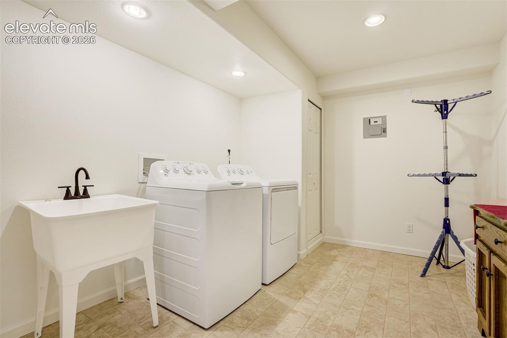 Basement Utility area featuring recessed lighting, a white floor-mounted utility sink with a high-arch faucet, and ceramic tile flooring