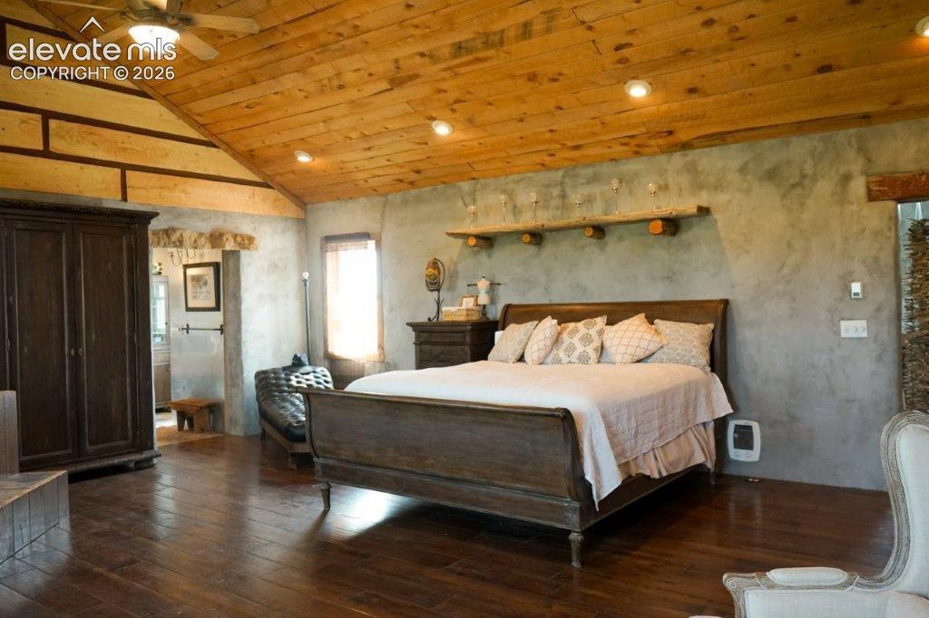 Vaulted wood-plank ceiling with recessed lighting and ceiling fan