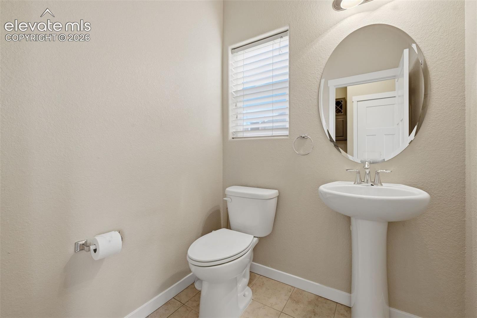 A convenient main-level powder bath serves guests without sending them upstairs.