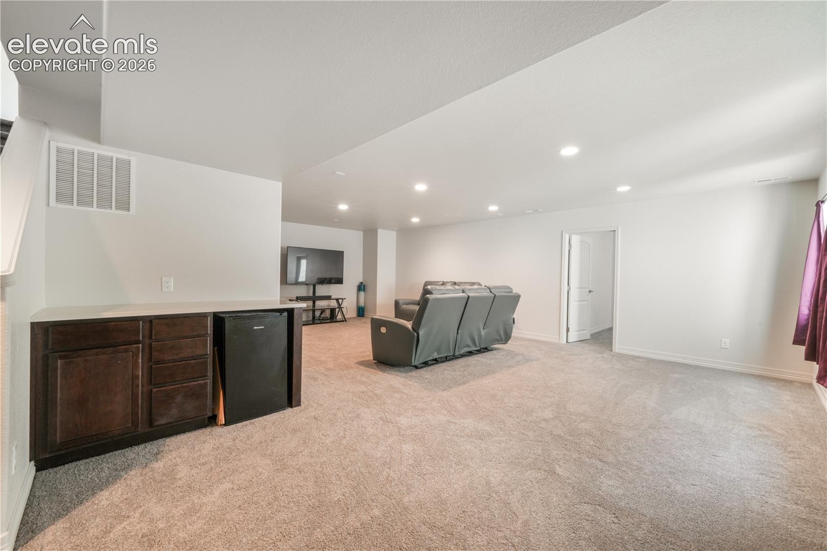 Basement family room with mini wet bar, new carpet