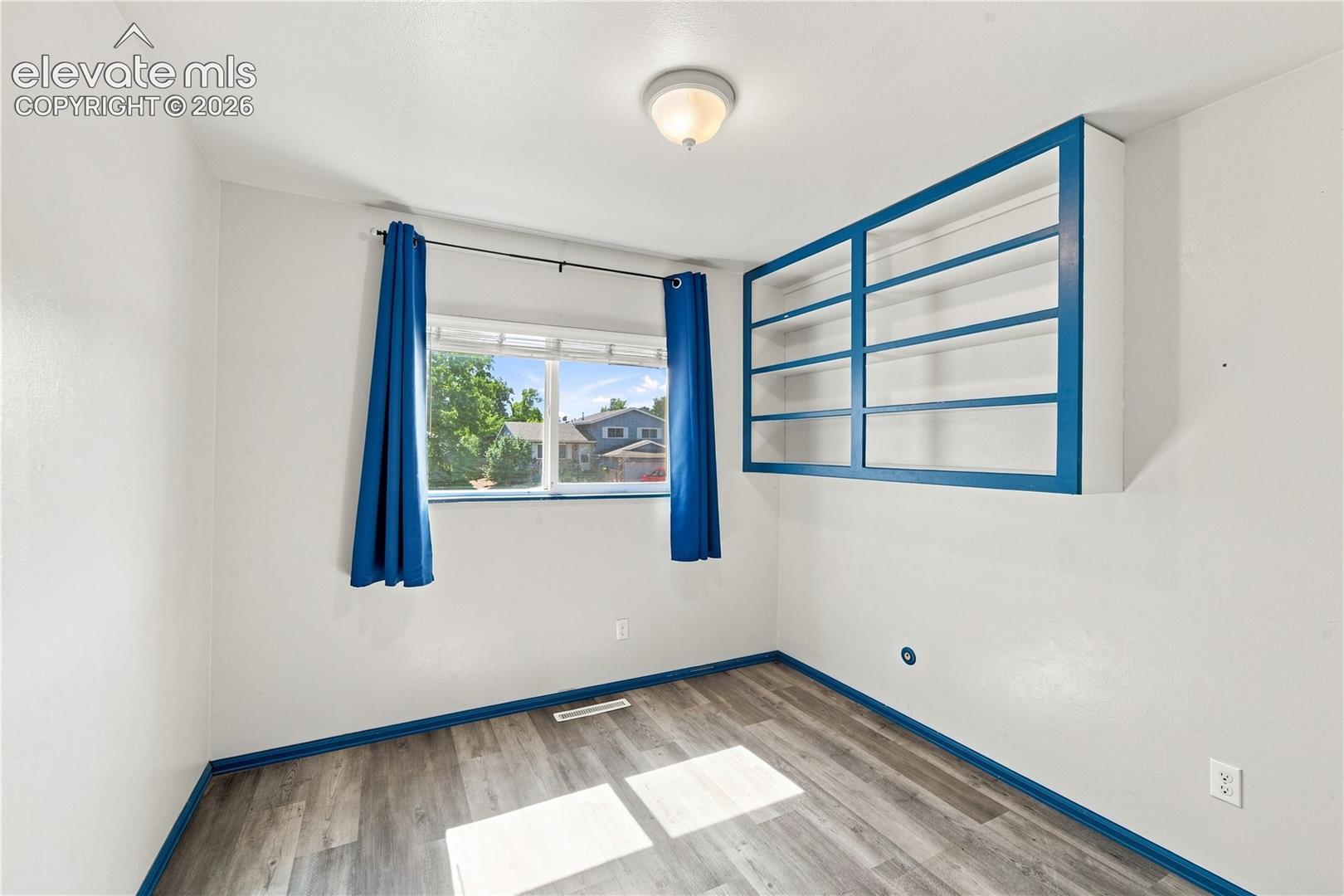 Wood-finish flooring with white walls and contrasting trim