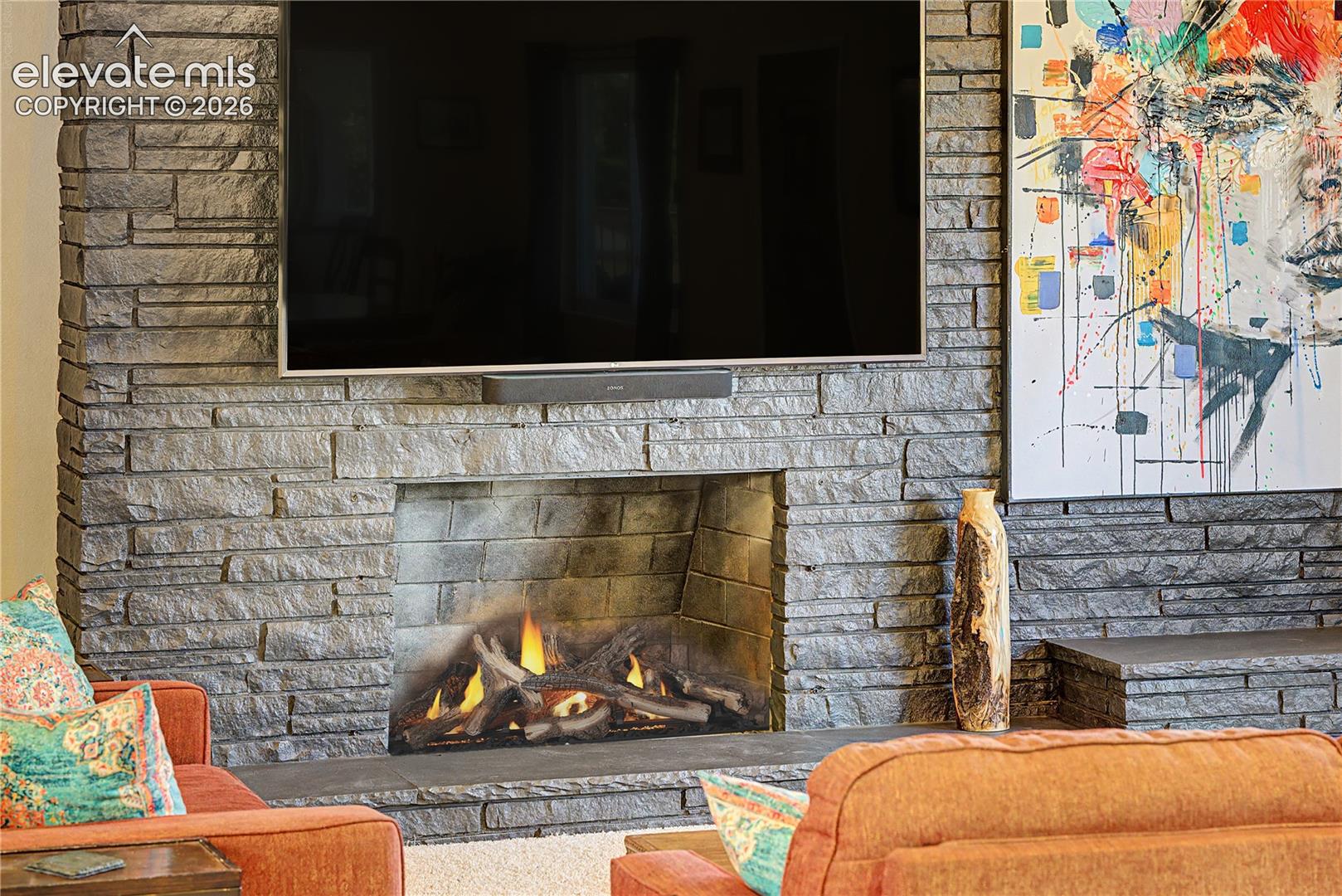 A closer look at the fireplace showcases the craftsmanship of the hand-stacked stone, a true centerpiece for cozy Colorado evenings.