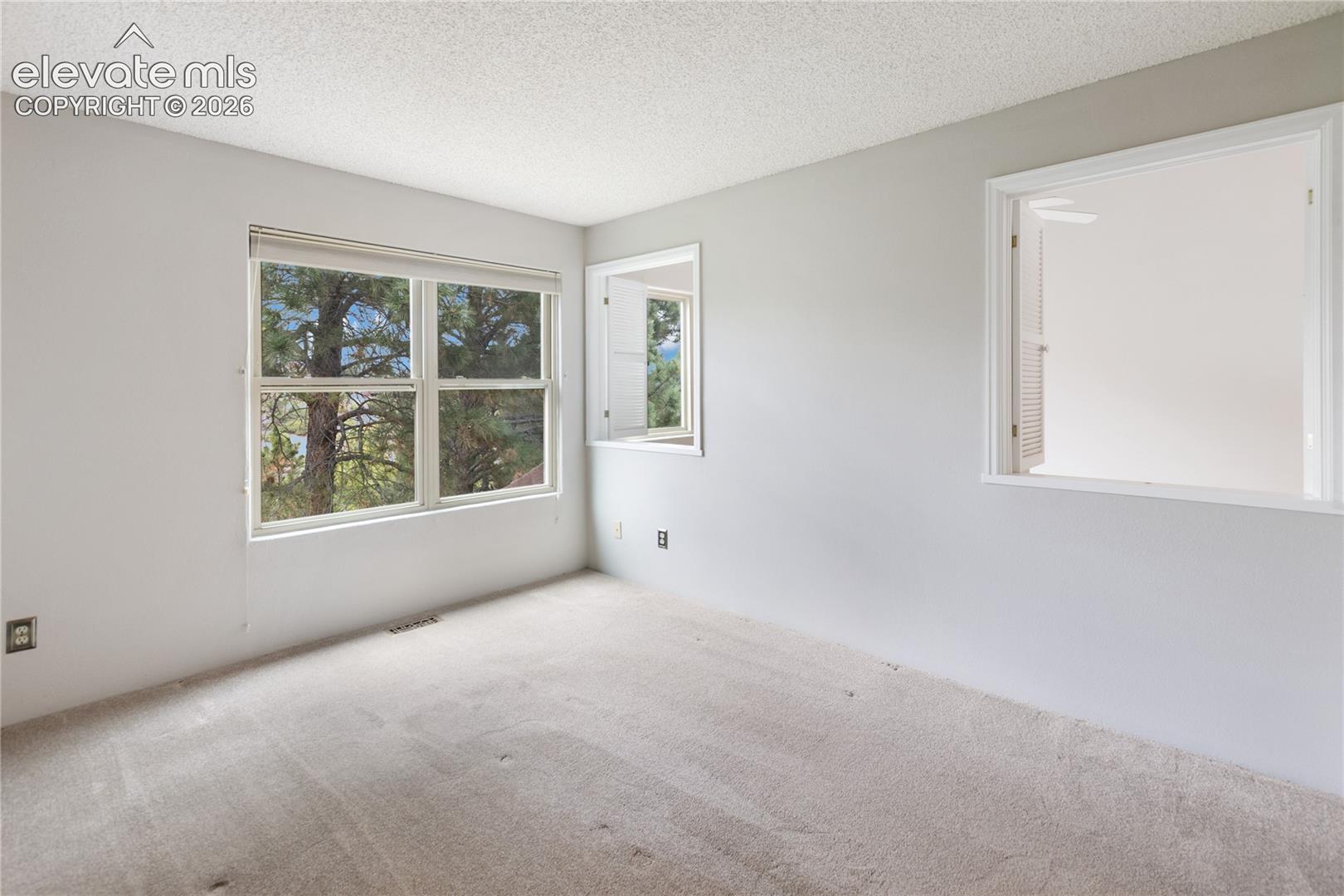 Upper bedroom with peekaboo windows to living room