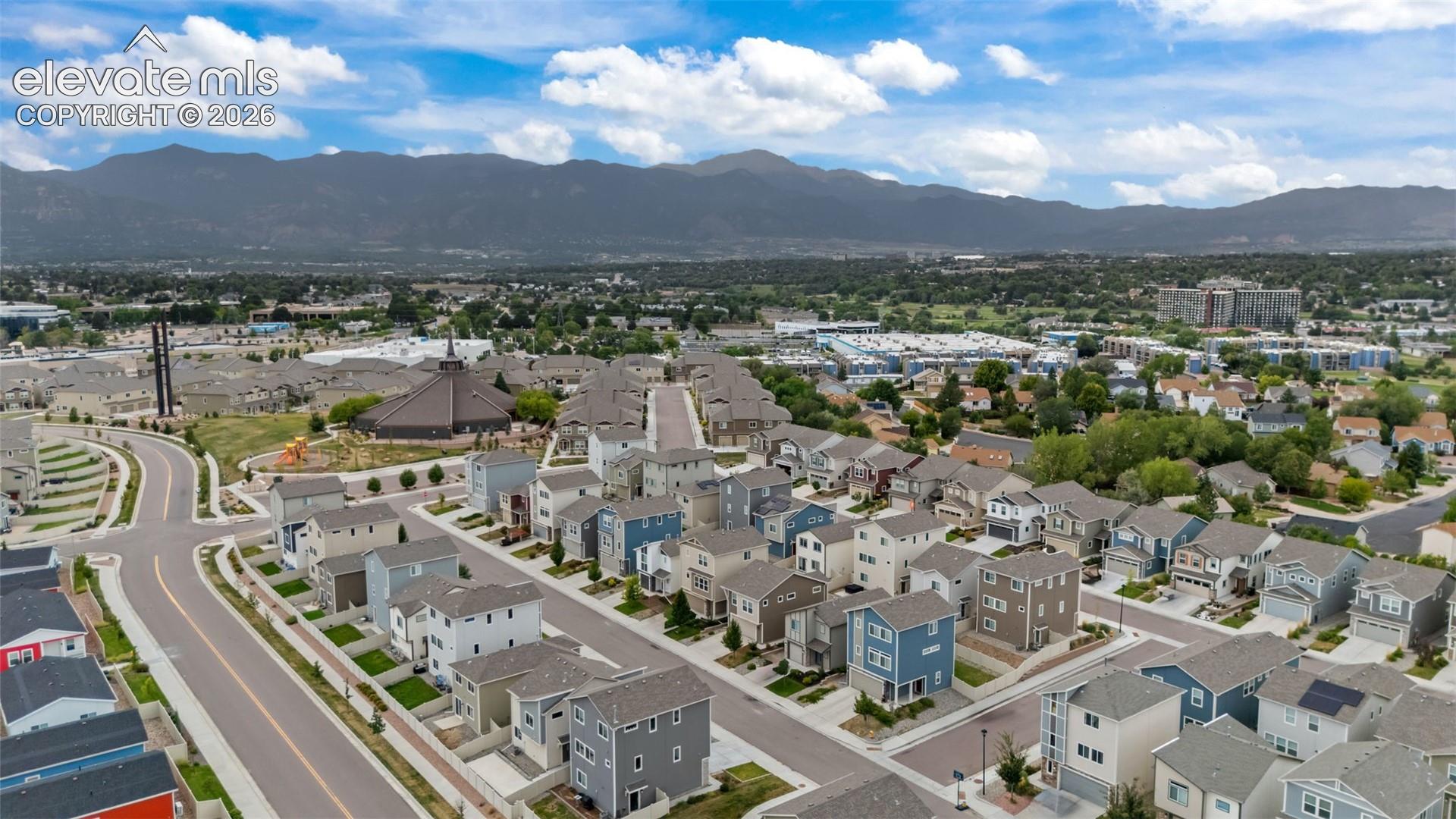 New construction residences within a developed community featuring mountain backdrops and a structured street grid