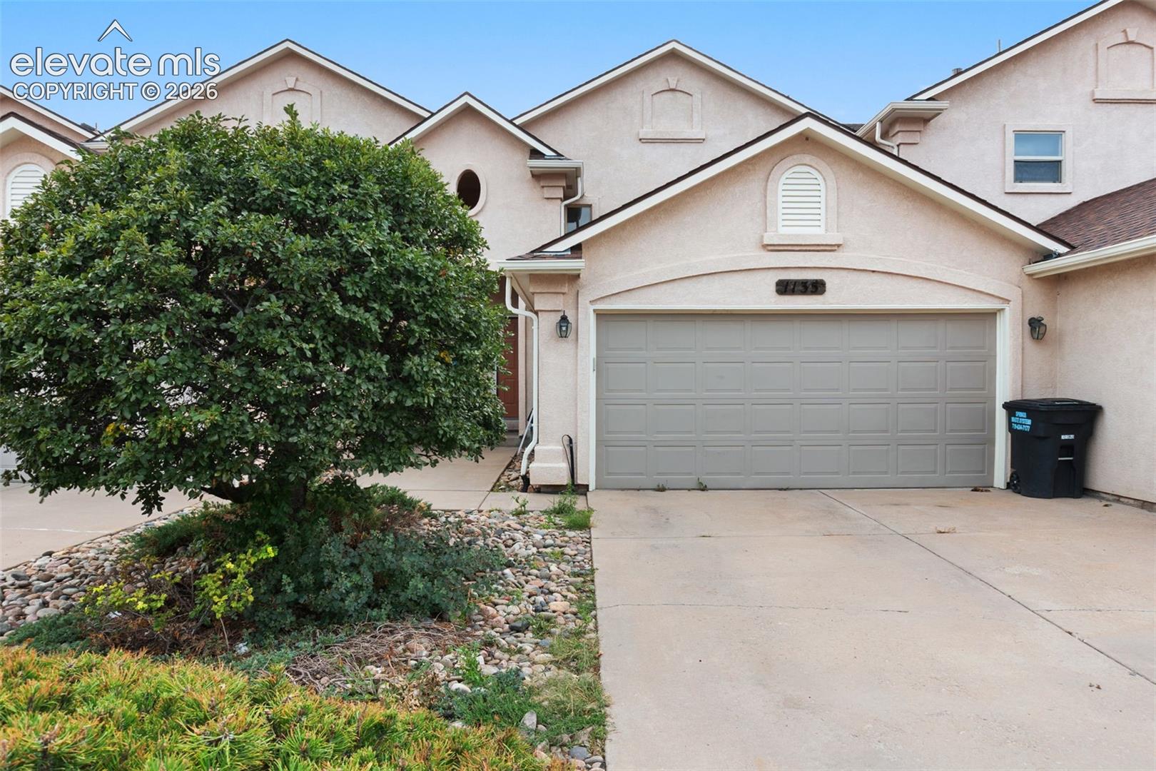Pikes Peak views, open space, and a fantastic Cragmor location highlight this spacious 3-bedroom, 3.5-bath townhome near UCCS. Enjoy mountain views from all three levels, including a main-level deck, private upper-level deck, and covered walkout patio. The bright main level features large windows, a gas fireplace, separate dining area, and kitchen with solid-surface countertops, breakfast bar, and stainless steel appliances. Upstairs, the primary suite offers a walk-in closet, 5-piece bath, and private deck with impressive Pikes Peak views, along with a second en suite bedroom and conveniently located laundry. The finished walkout basement includes a large family room, third bedroom, 3/4 bath, private exterior entrance, and covered patio—ideal for guests, a roommate setup, or additional living space. Backing to open space with direct access to a walking and biking trail, this home combines incredible views, flexible living space, and a convenient central location. Come for the location, stay for the views.