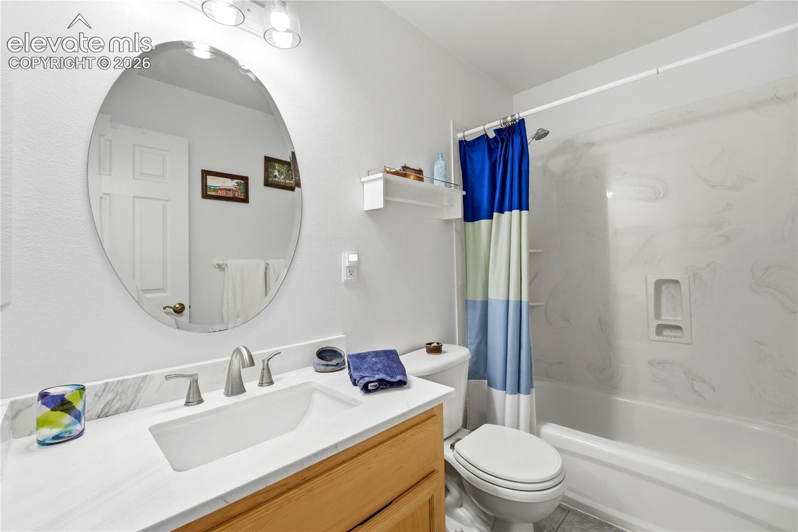 Vanity with white countertop, undermount sink, and brushed nickel faucet