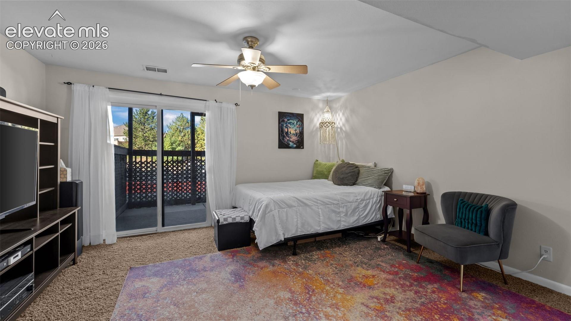 Sliding glass door with access to a railed balcony and a ceiling fan with integrated lighting