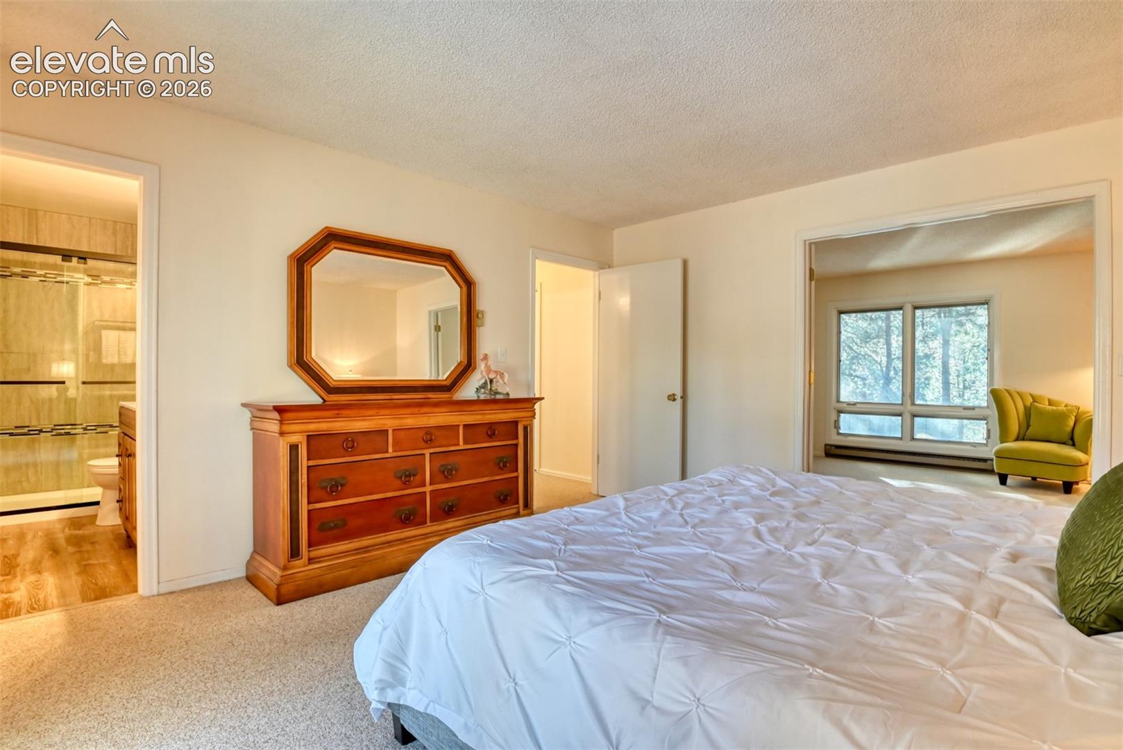 Primary bedroom suite has private updated 3/4 bathroom, attached office/sitting room and spacious walk-in closet.